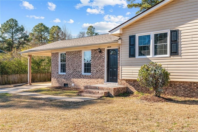 view of front of house featuring brick siding, crawl space, a front yard, and fence