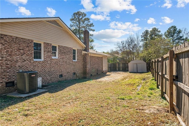 view of yard with a storage shed, central AC, an outdoor structure, and a fenced backyard