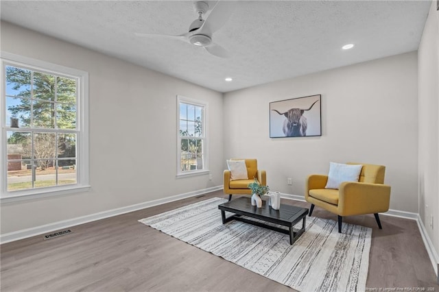6815 Radial Dr, Fayetteville, NC 28311 - living area featuring healthy amount of natural light, a textured ceiling, wood finished floors, recessed lighting, and ceiling fan
