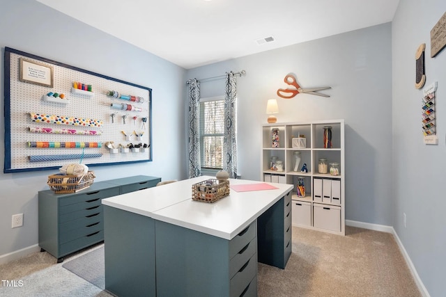 home office featuring light colored carpet, visible vents, and baseboards