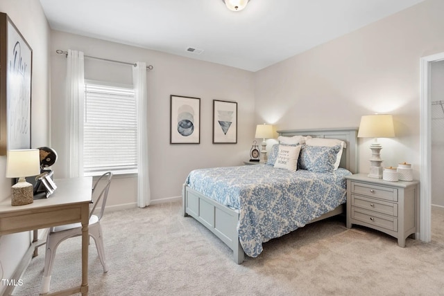 bedroom with baseboards, visible vents, and light colored carpet