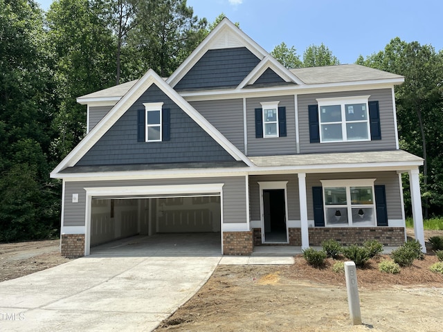 507 Olivia Crossing Ct Unit 20, Four Oaks, NC 27524 - craftsman-style house with brick siding, covered porch, driveway, and a shingled roof