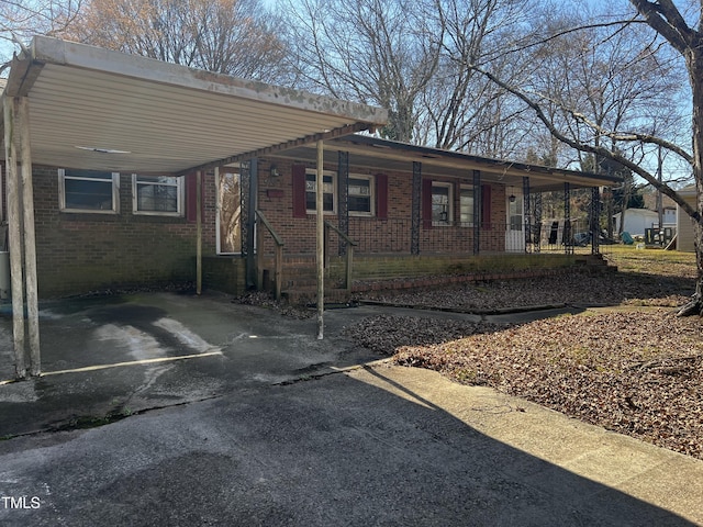 view of front of home with brick siding and aphalt driveway