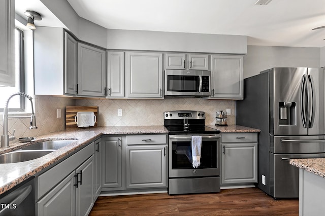 kitchen featuring gray cabinets, appliances with stainless steel finishes, and a sink