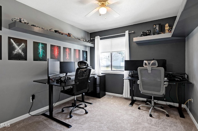 office space featuring carpet, a ceiling fan, and baseboards