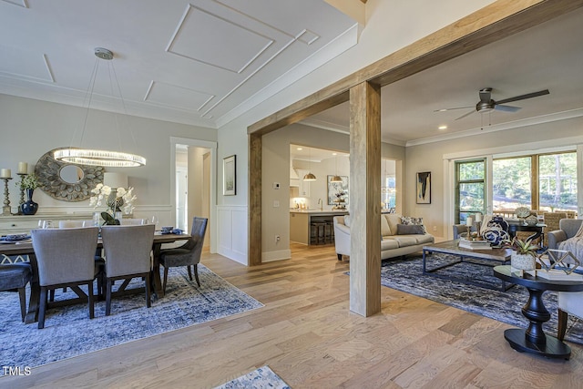 25 Blackhorn Ct, Pittsboro, NC 27312 - living area featuring a wainscoted wall, light wood finished floors, a decorative wall, and crown molding