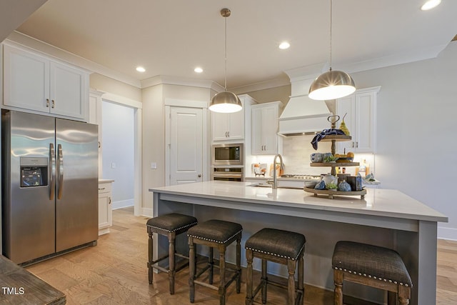 25 Blackhorn Ct, Pittsboro, NC 27312 - kitchen with stainless steel appliances, light countertops, and a center island with sink