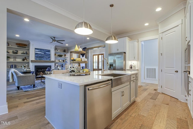 25 Blackhorn Ct, Pittsboro, NC 27312 - kitchen with visible vents, appliances with stainless steel finishes, open floor plan, a kitchen island with sink, and white cabinetry