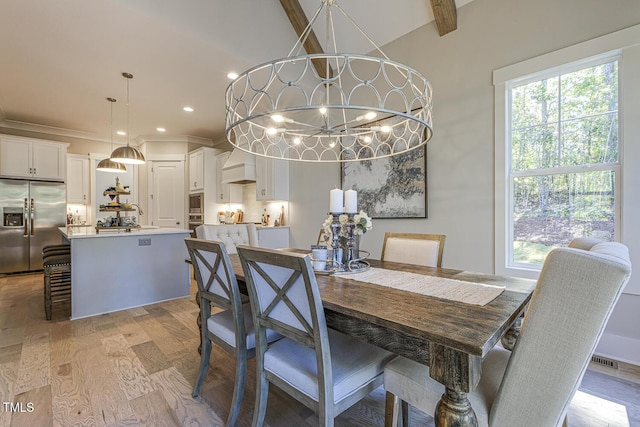 25 Blackhorn Ct, Pittsboro, NC 27312 - dining area featuring vaulted ceiling, recessed lighting, light wood-style flooring, and an inviting chandelier