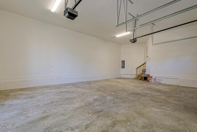 25 Blackhorn Ct, Pittsboro, NC 27312 - garage featuring a garage door opener, concrete block wall, and electric panel
