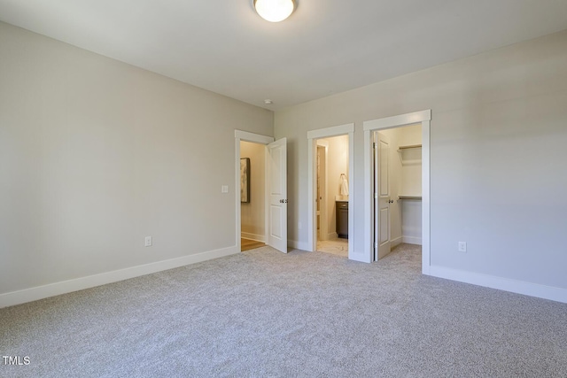 25 Blackhorn Ct, Pittsboro, NC 27312 - unfurnished bedroom with a closet, light colored carpet, a spacious closet, and baseboards