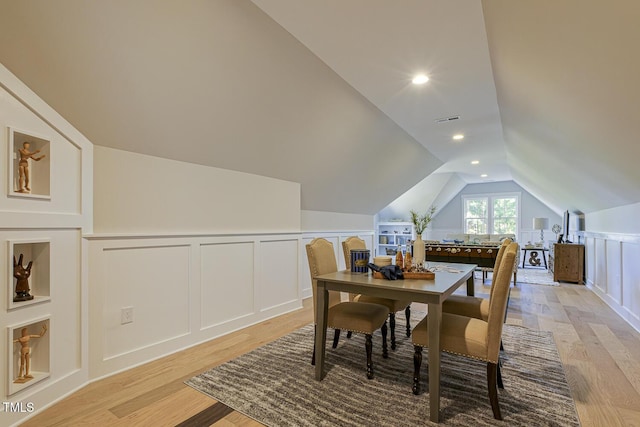 25 Blackhorn Ct, Pittsboro, NC 27312 - dining room with lofted ceiling, light wood-type flooring, visible vents, and a decorative wall