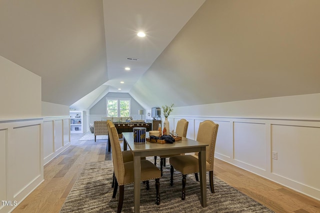 25 Blackhorn Ct, Pittsboro, NC 27312 - dining room featuring light wood-type flooring, visible vents, a decorative wall, and lofted ceiling