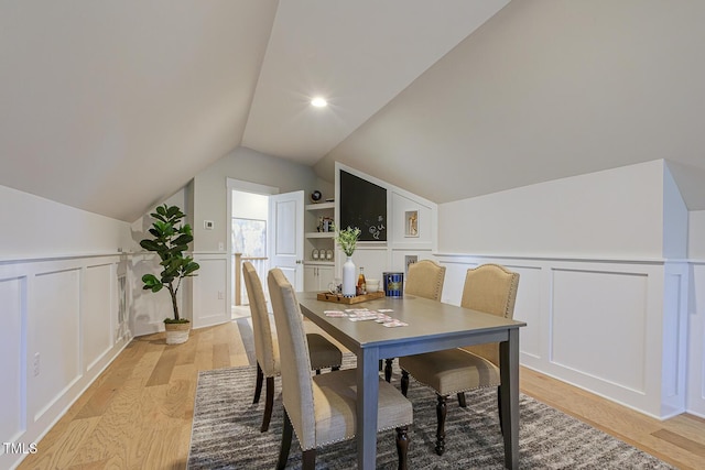 25 Blackhorn Ct, Pittsboro, NC 27312 - dining space featuring vaulted ceiling, light wood finished floors, and a decorative wall