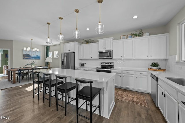 kitchen featuring white cabinets, pendant lighting, and stainless steel appliances