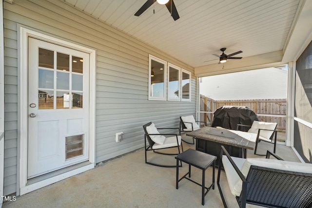 view of patio featuring a grill, fence, and a ceiling fan