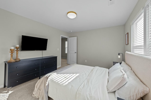 bedroom with visible vents and light colored carpet