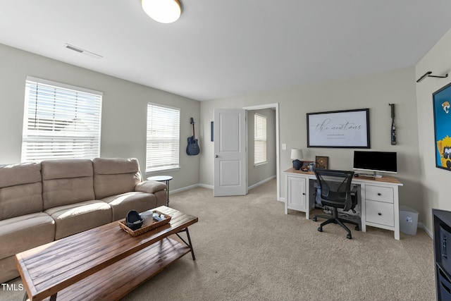 interior space featuring baseboards, visible vents, and light colored carpet