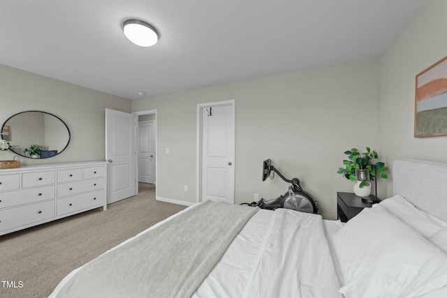 bedroom featuring light carpet and baseboards