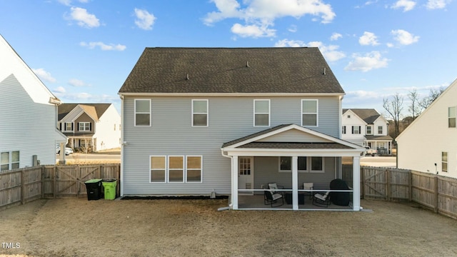 rear view of house with a residential view, a fenced backyard, and a patio