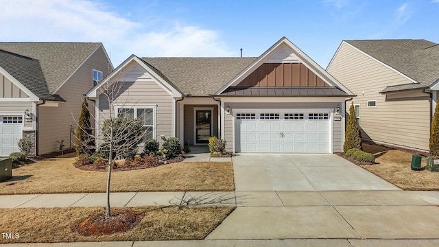 craftsman-style home with a garage, driveway, and board and batten siding