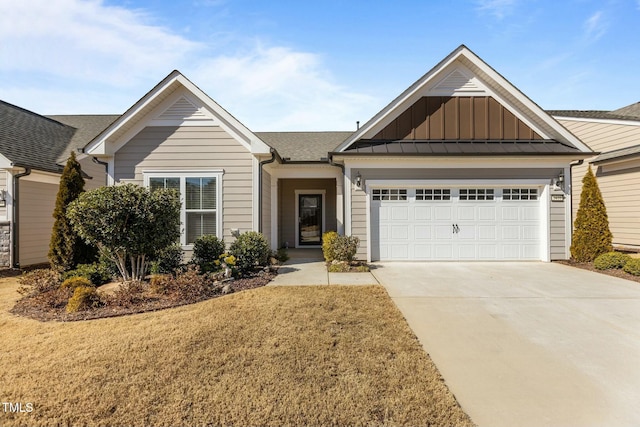 ranch-style house with board and batten siding, a front yard, concrete driveway, and an attached garage