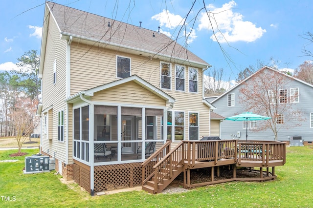 back of house featuring roof with shingles, a sunroom, a deck, central air condition unit, and a lawn