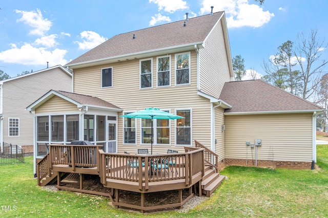 back of property with a yard, roof with shingles, a deck, and a sunroom