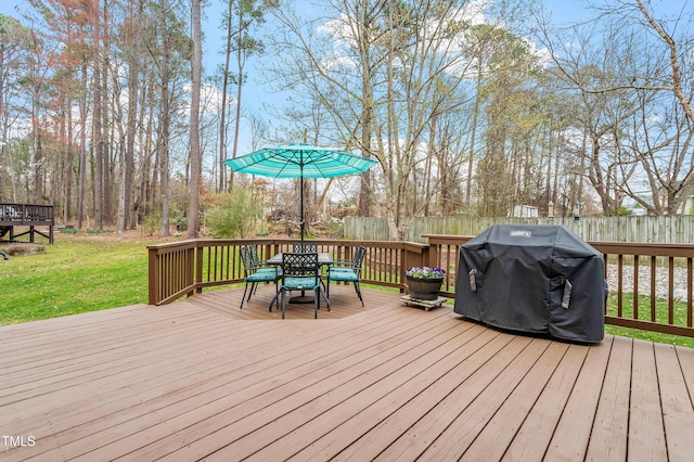 deck with area for grilling, a yard, and fence