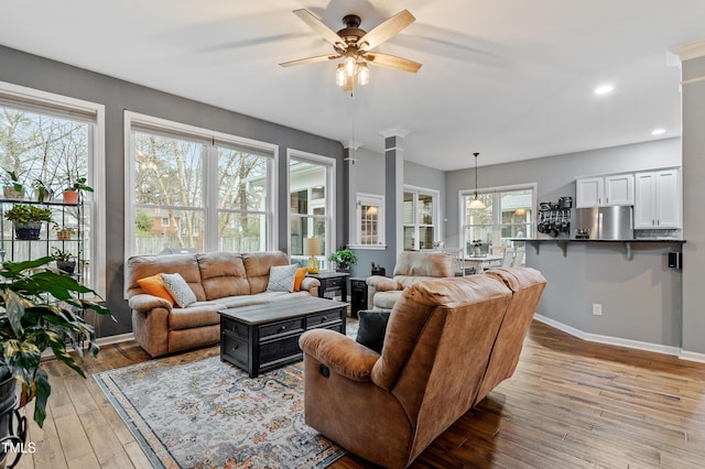 living area featuring recessed lighting, light wood-style flooring, baseboards, and a ceiling fan