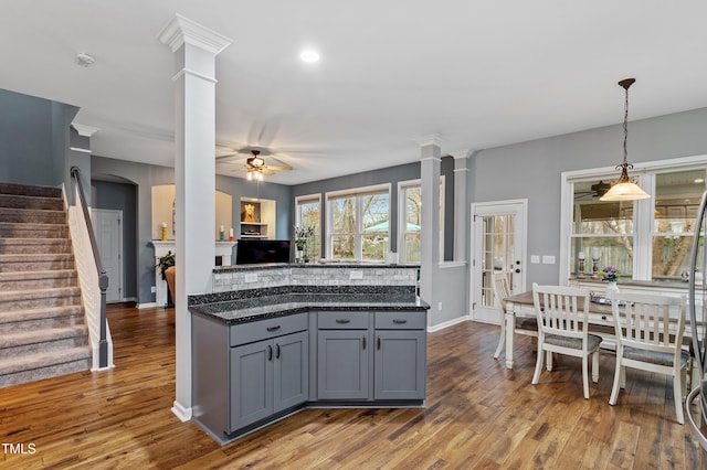 kitchen featuring wood finished floors, a ceiling fan, and ornate columns