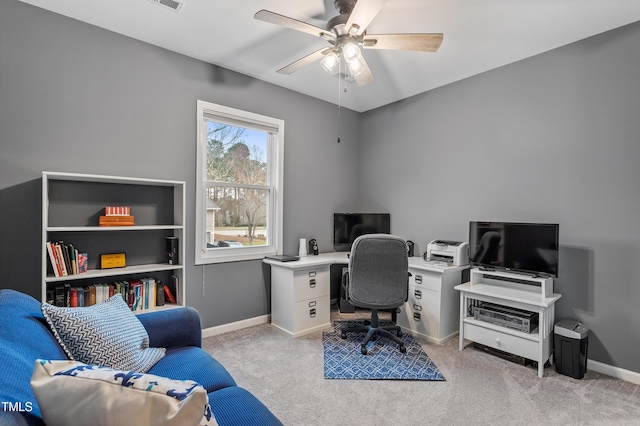 office featuring visible vents, a ceiling fan, light colored carpet, and baseboards