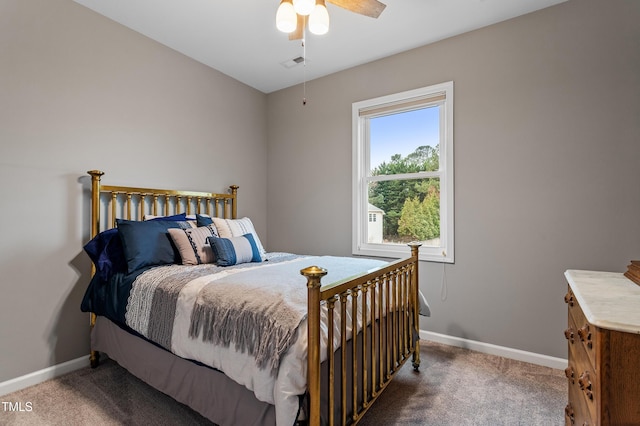 carpeted bedroom featuring a ceiling fan, visible vents, and baseboards