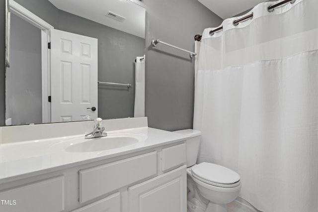 bathroom featuring visible vents, toilet, and vanity