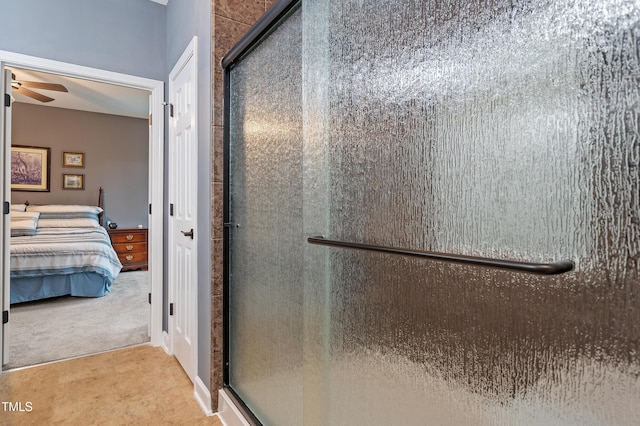 full bathroom featuring a stall shower, ensuite bathroom, and ceiling fan