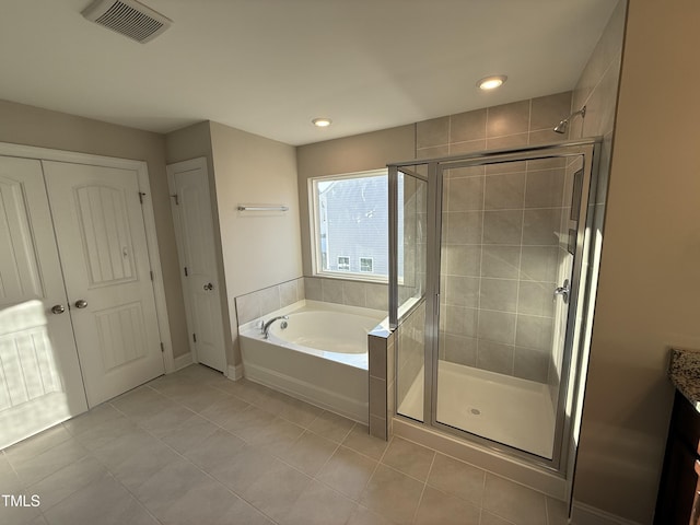 bathroom with a stall shower, visible vents, tile patterned flooring, vanity, and a bath