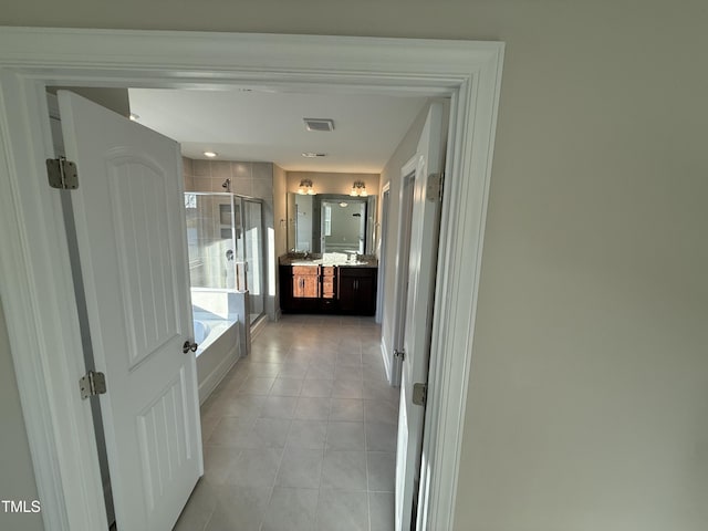 hallway with light tile patterned flooring and visible vents