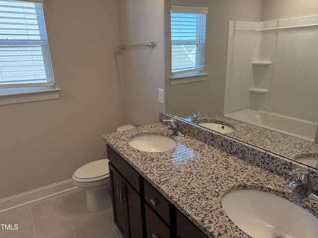 full bath with toilet, tile patterned flooring, and a sink