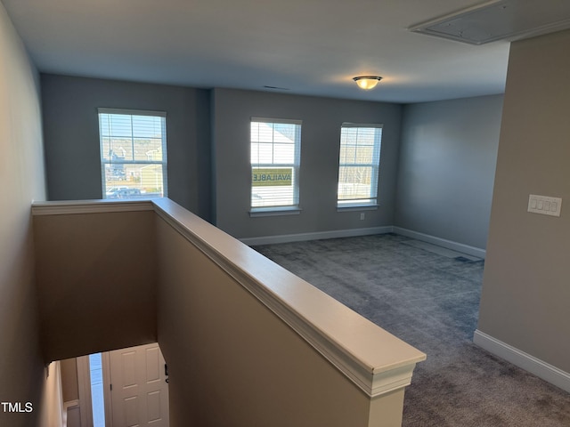 staircase with carpet floors, attic access, and baseboards