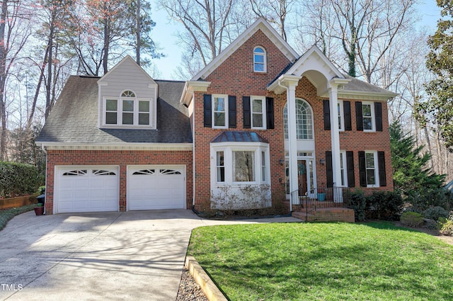 view of front facade featuring brick siding, driveway, a front lawn, and a garage