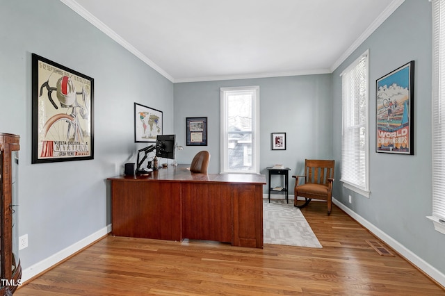 office featuring ornamental molding, visible vents, light wood-type flooring, and baseboards