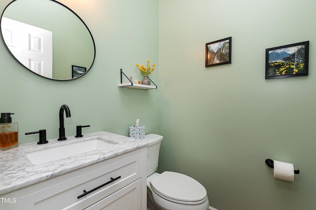 half bathroom with toilet and vanity