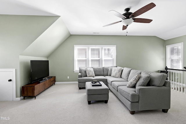 living area featuring a wealth of natural light, light colored carpet, a ceiling fan, and vaulted ceiling