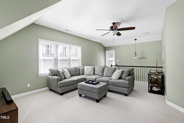 living room with visible vents, baseboards, light colored carpet, ceiling fan, and vaulted ceiling