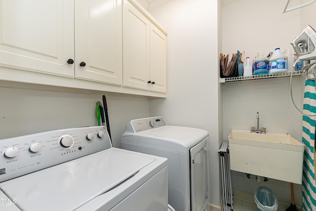 laundry area with a sink, cabinet space, and independent washer and dryer