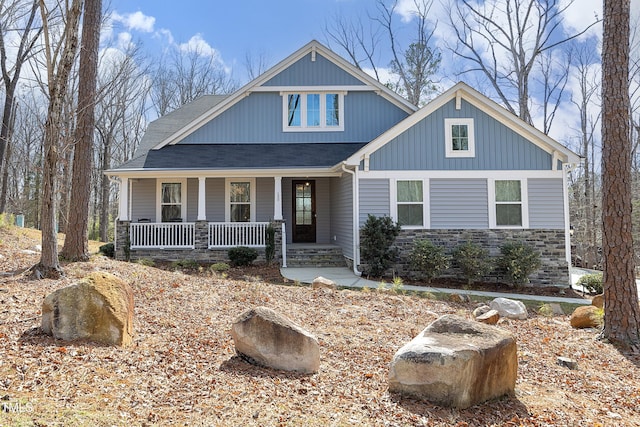 craftsman inspired home featuring stone siding and covered porch