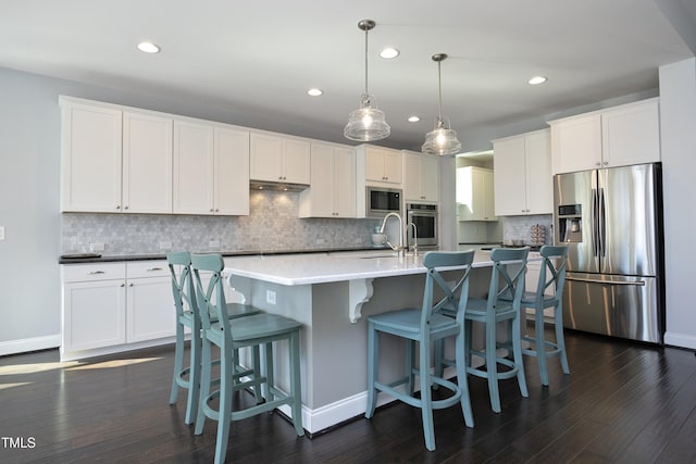 kitchen featuring white cabinetry, dark wood-style flooring, and stainless steel appliances