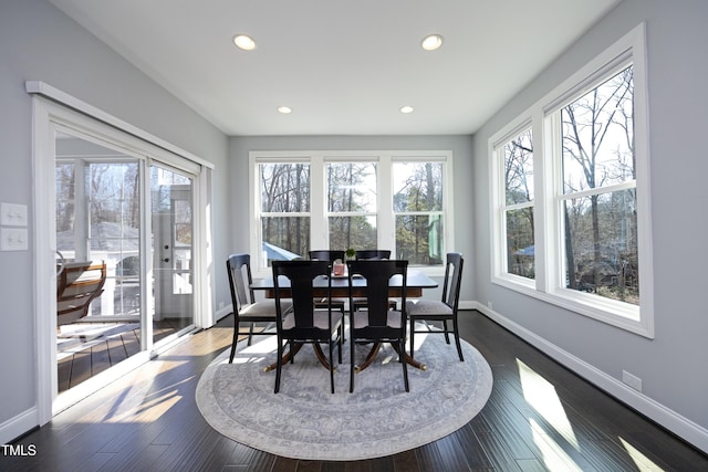 dining room with dark wood finished floors, recessed lighting, and baseboards