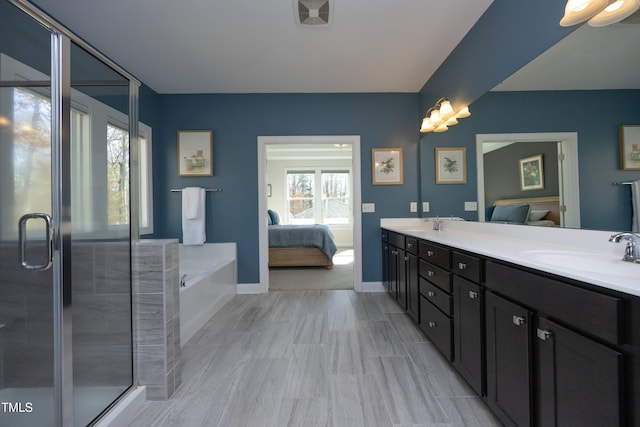 full bathroom with visible vents, a garden tub, double vanity, ensuite bath, and a sink