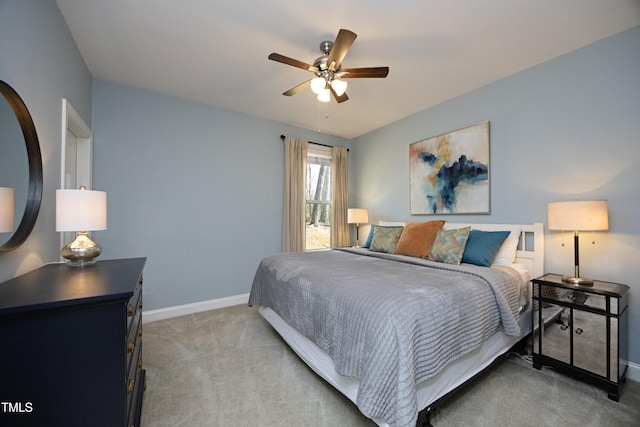 bedroom featuring light colored carpet, baseboards, and ceiling fan